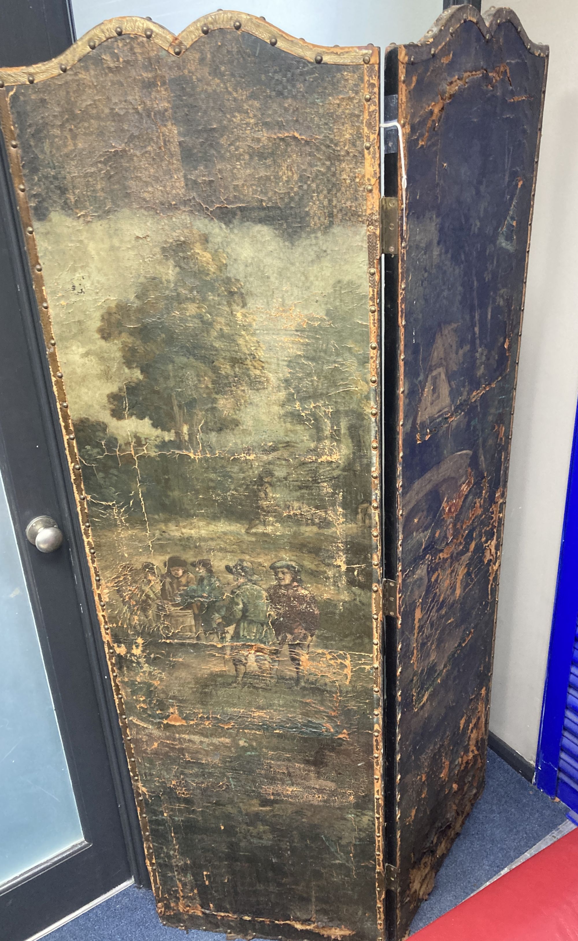 A 19th century Spanish four leaf draught screen, painted with a village scene with numerous figures, each panel width 52cm, height 184c